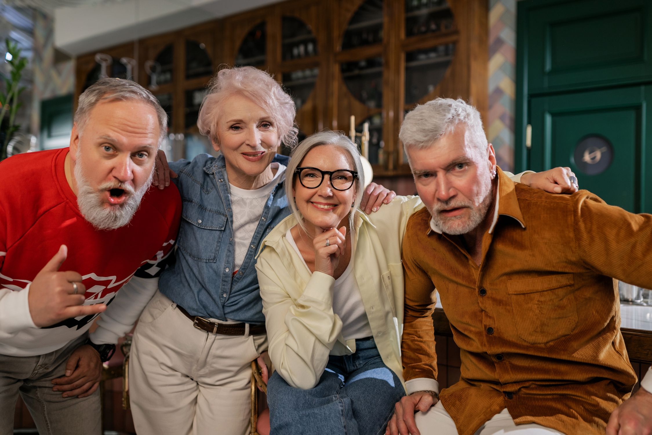 Five older women chatting together on a bench in an urban public space